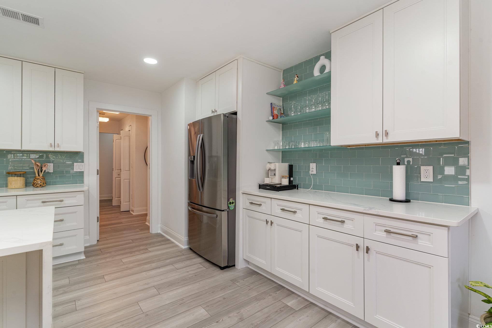 5811 Sumter Drive Myrtle Beach, SC 29577 - Photo 10 of 39 Kitchen featuring tasteful backsplash, open shelves, stainless steel refrigerator with ice dispenser, white cabinetry, and recessed lighting