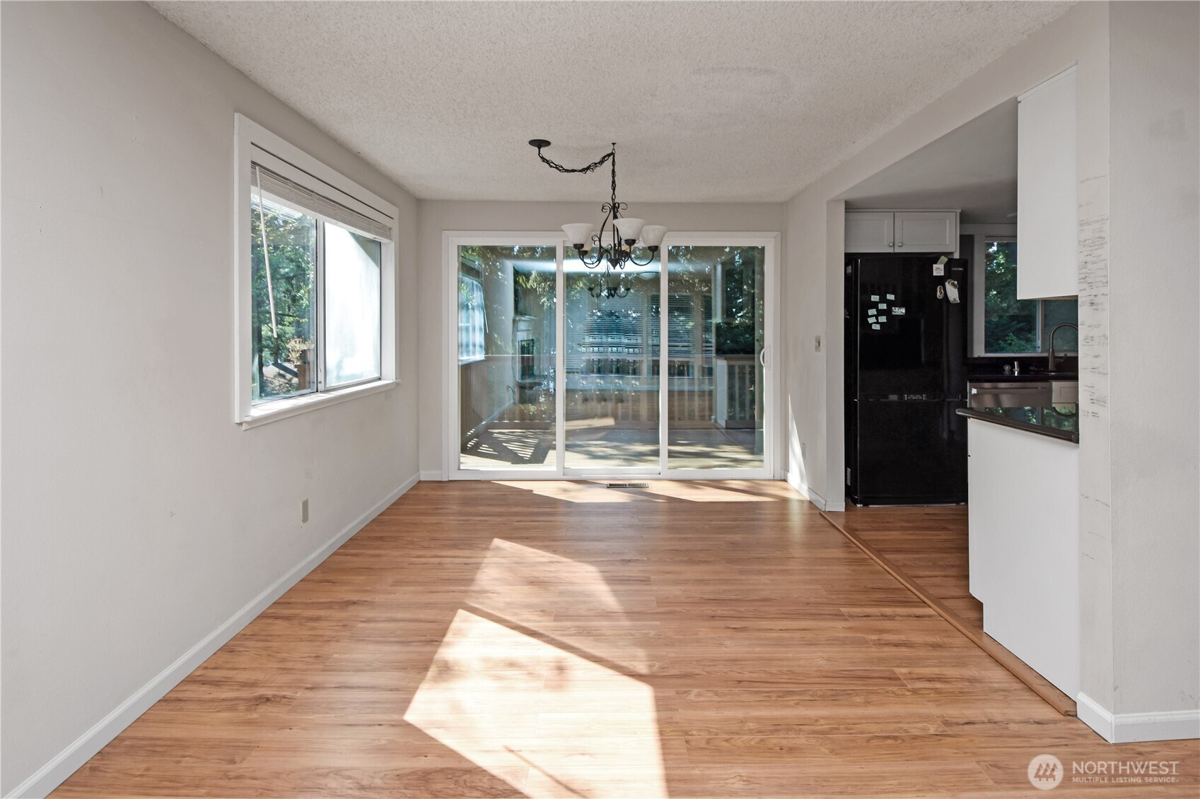308 Point Fosdick Place Northwest Gig Harbor, WA 98335 - Photo 14 of 35 a view of an empty room with wooden floor and a window