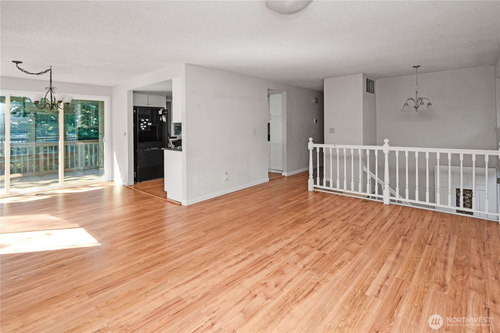 308 Point Fosdick Place Northwest Gig Harbor, WA 98335 - Photo 17 of 35 a view of empty room with wooden floor and fan