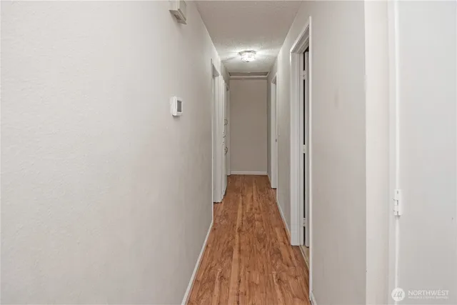 a view of a hallway with wooden floor