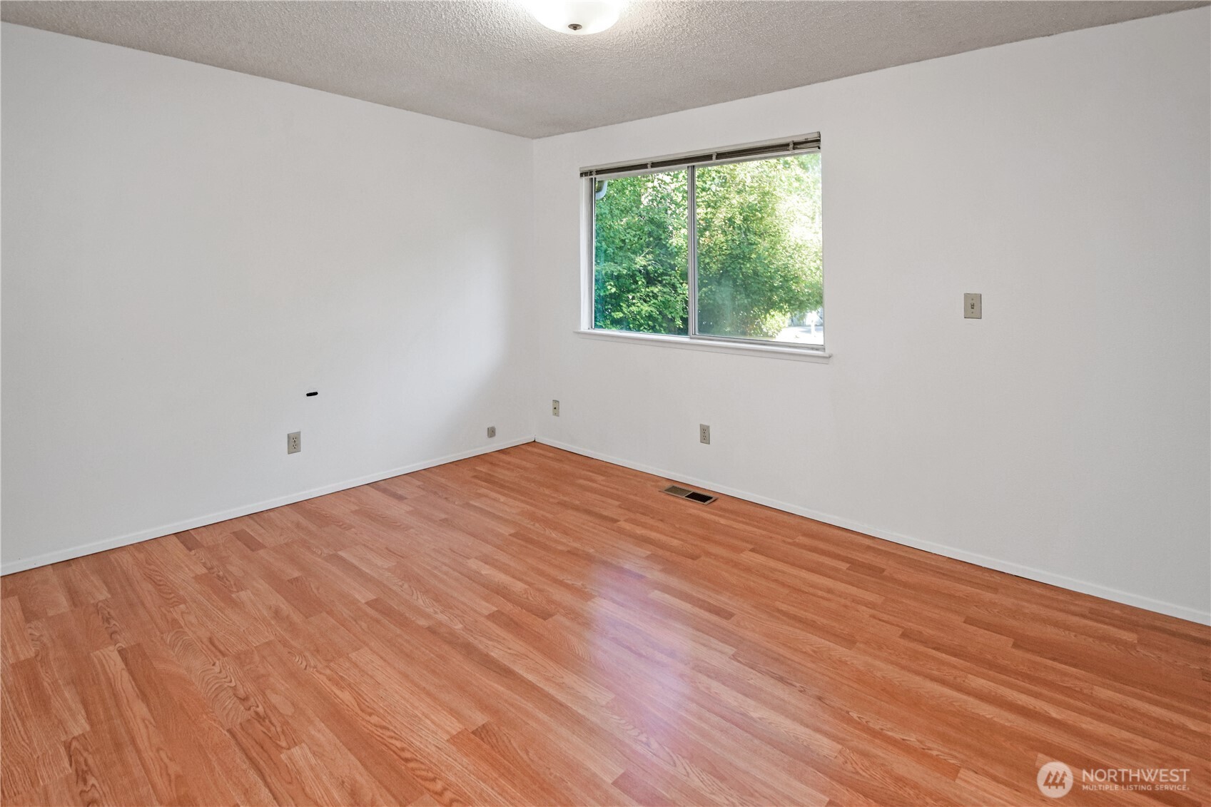 308 Point Fosdick Place Northwest Gig Harbor, WA 98335 - Photo 24 of 35 an empty room with wooden floor and windows