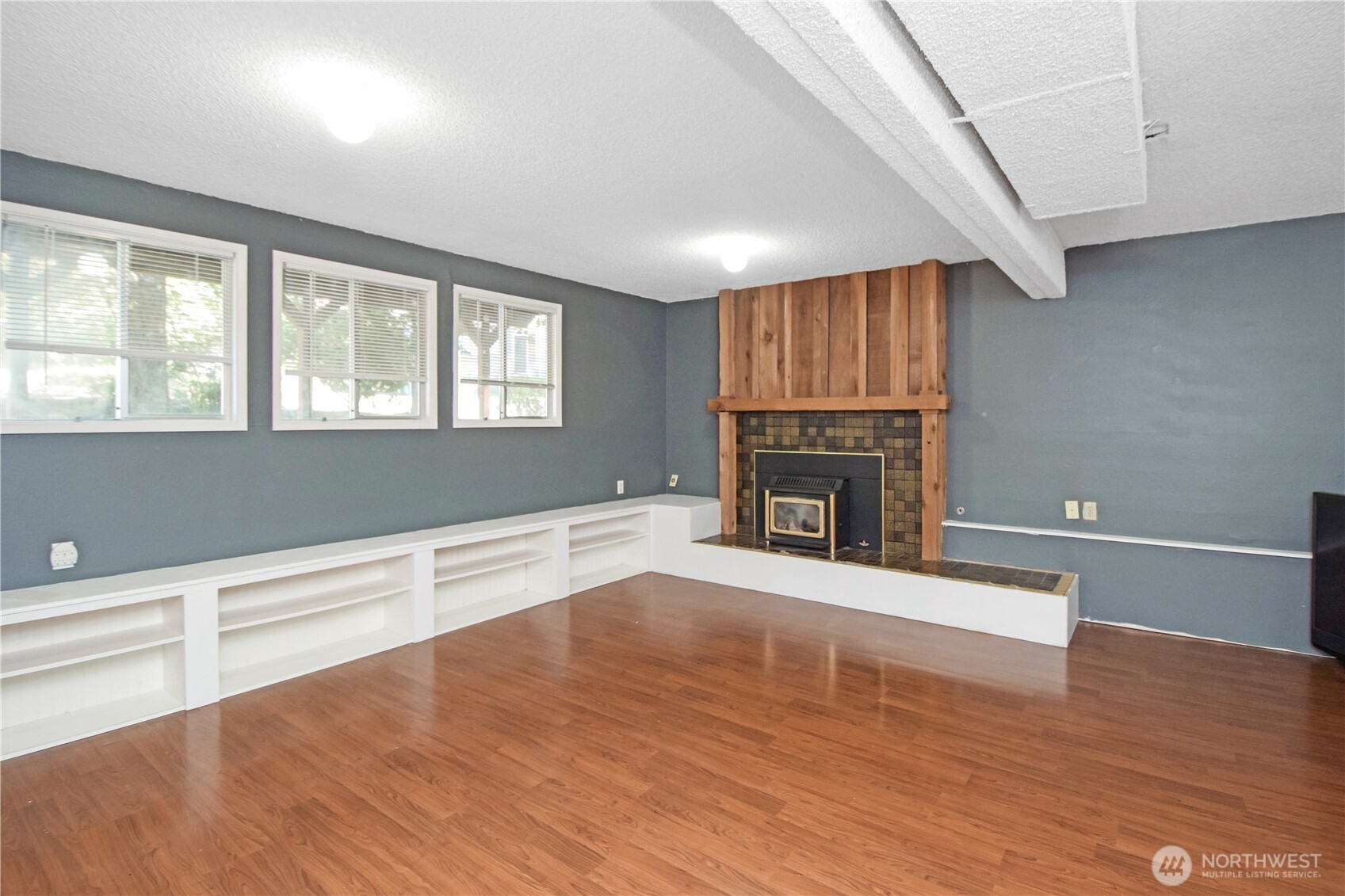 308 Point Fosdick Place Northwest Gig Harbor, WA 98335 - Photo 29 of 35 a view of an empty room with wooden floor and a window