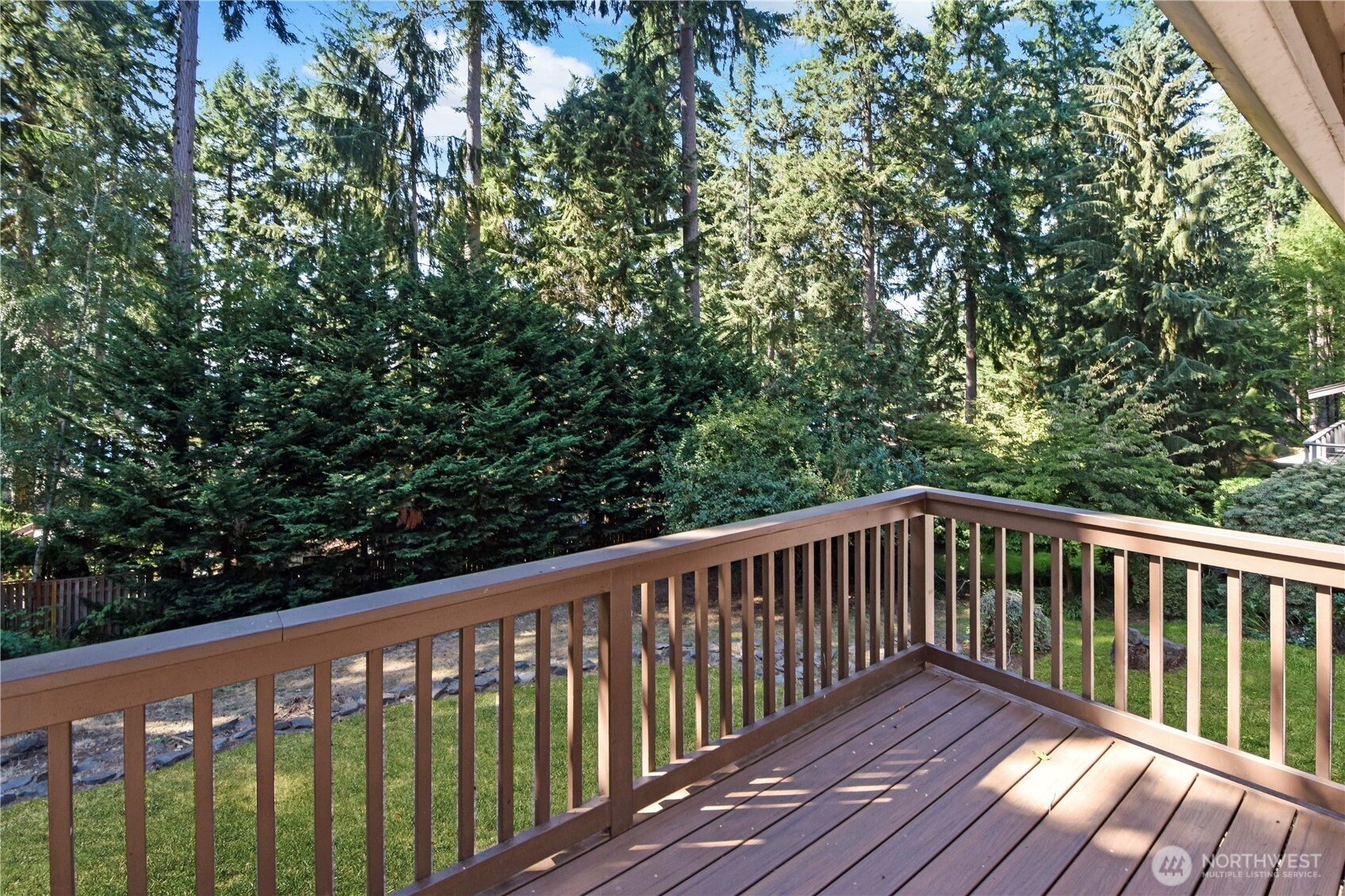 308 Point Fosdick Place Northwest Gig Harbor, WA 98335 - Photo 7 of 35 a wooden deck with trees in front of it