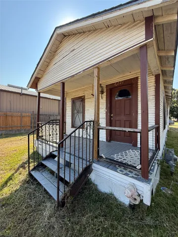 a view of a house with wooden floor roof and furniture