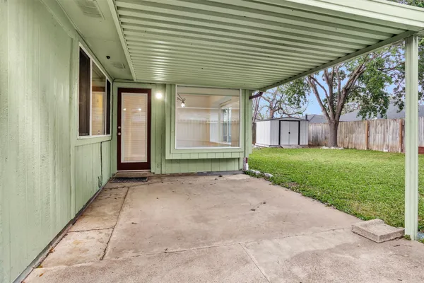 a view of a house with backyard and a tree