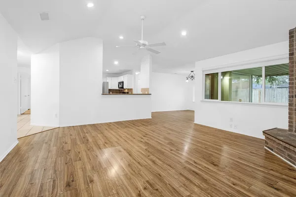 a view of a room with wooden floor and window