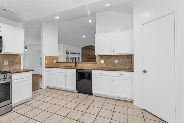 a kitchen with a sink cabinets and appliances