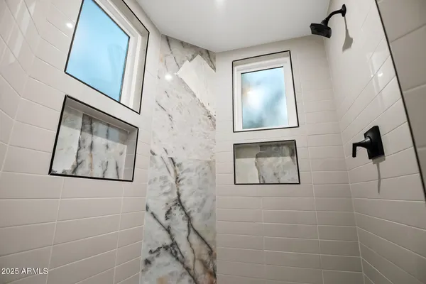 a bathroom with a double vanity sink toilet and shower