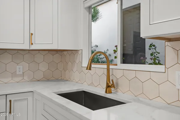 a view of a kitchen with a sink cabinets and stainless steel appliances