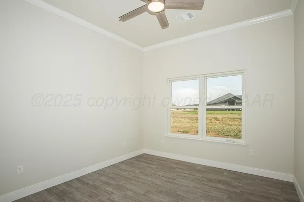 an empty room with a window and wooden floor