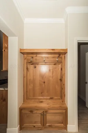 an empty room with wooden floor and a ceiling fan