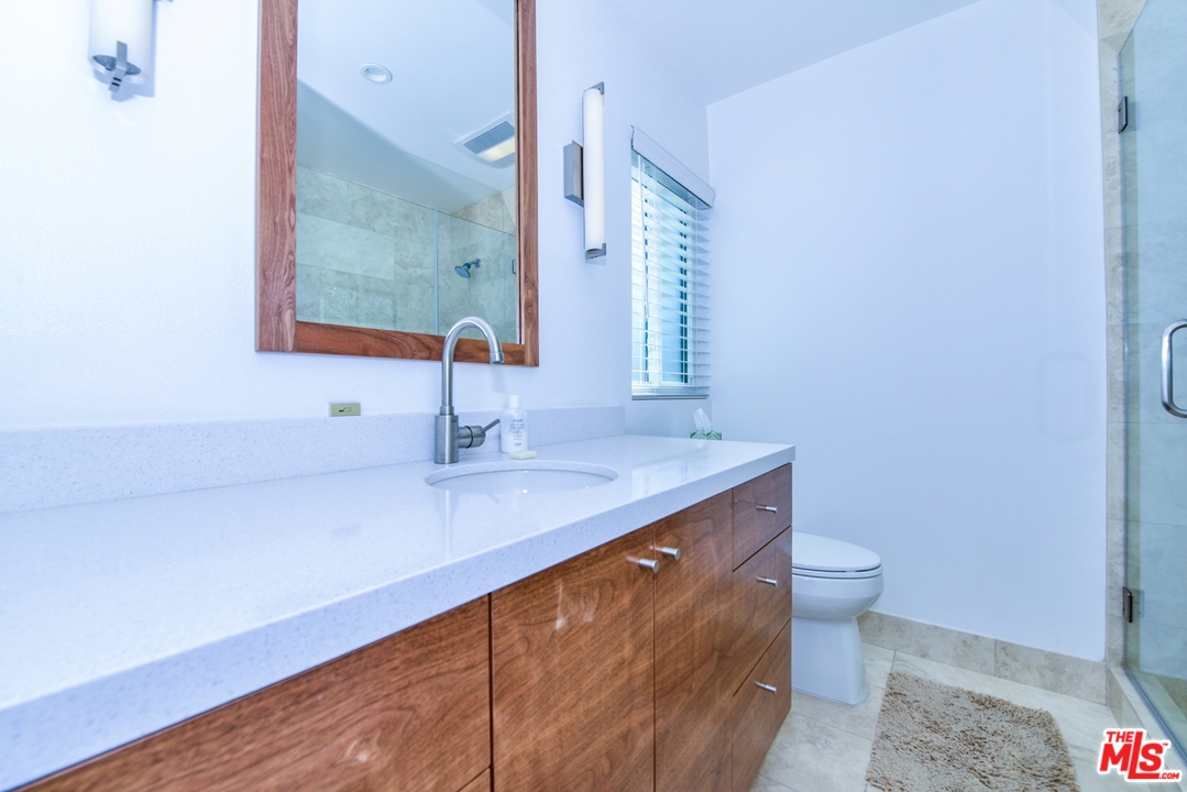 914 2nd Street, Unit B Santa Monica, CA 90403 - Photo 15 of 29 a bathroom with a sink and a mirror