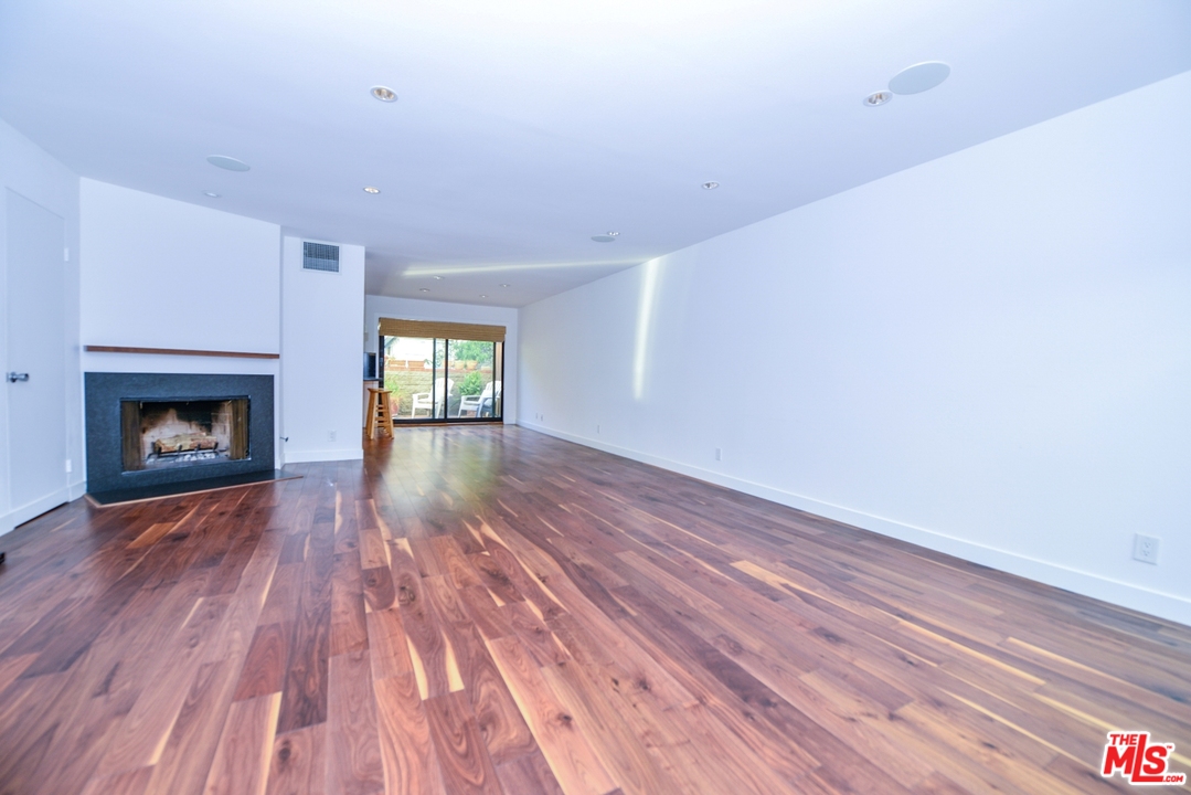 914 2nd Street, Unit B Santa Monica, CA 90403 - Photo 23 of 29 a view of an empty room with wooden floor fireplace and a window