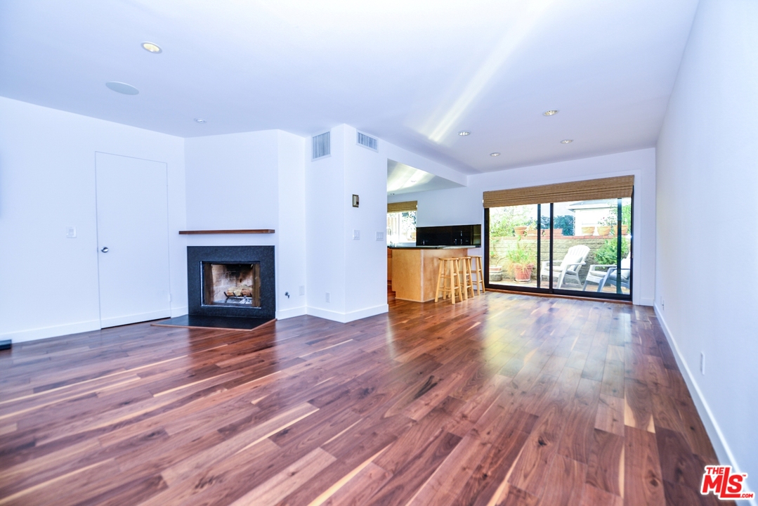 914 2nd Street, Unit B Santa Monica, CA 90403 - Photo 4 of 29 a view of empty room with a fireplace and wooden floor