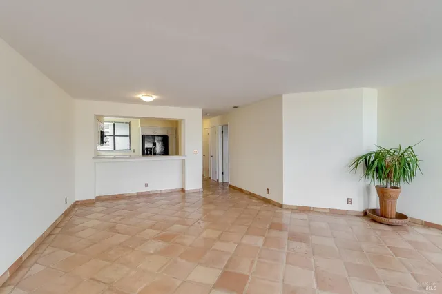 a view of livingroom with window and potted plant