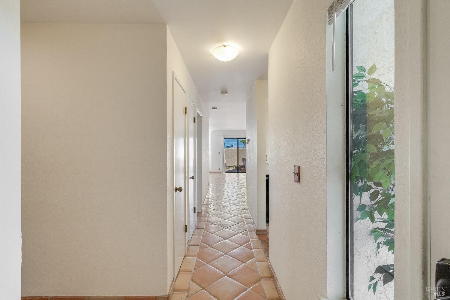 171 Nantucket Lane Vallejo, CA 94590 - Photo 16 of 56 a view of a hallway with wooden floor and a dining room