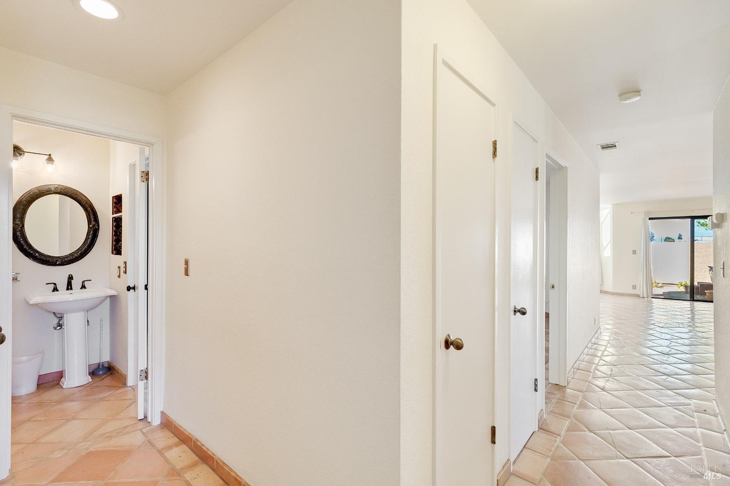 171 Nantucket Lane Vallejo, CA 94590 - Photo 19 of 56 a view of a hallway with wooden floor and a bathroom