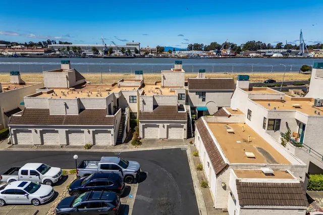 an aerial view of a building with a garden and parking space