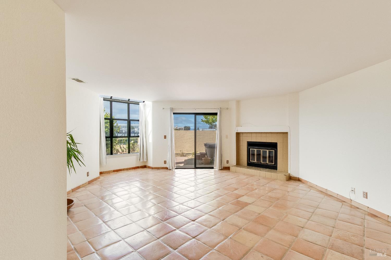 171 Nantucket Lane Vallejo, CA 94590 - Photo 9 of 56 a view of an empty room with a fireplace and a window