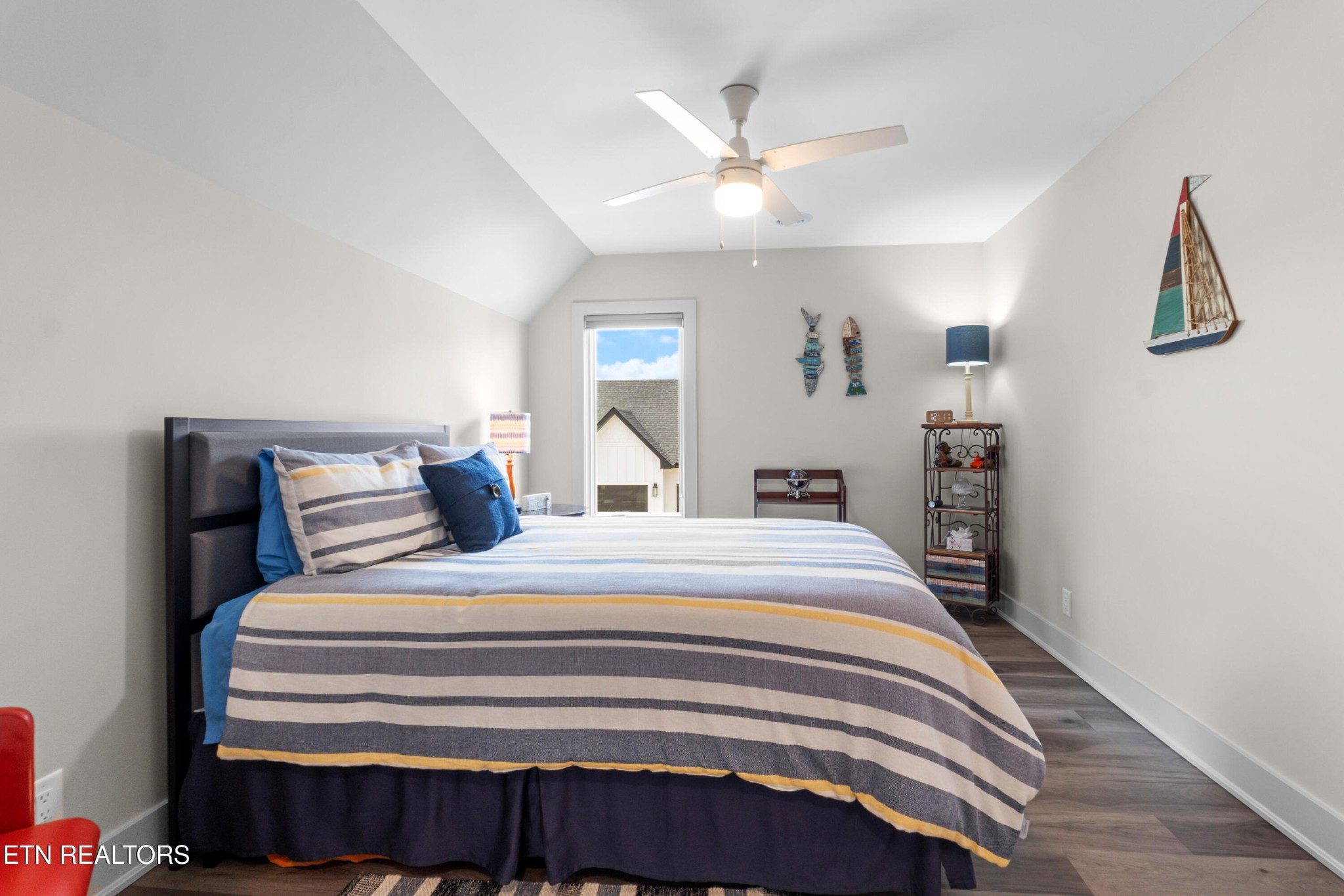 3702 Promontory Point Louisville, TN 37777 - Photo 32 of 60 a bedroom with a bed and a chandelier