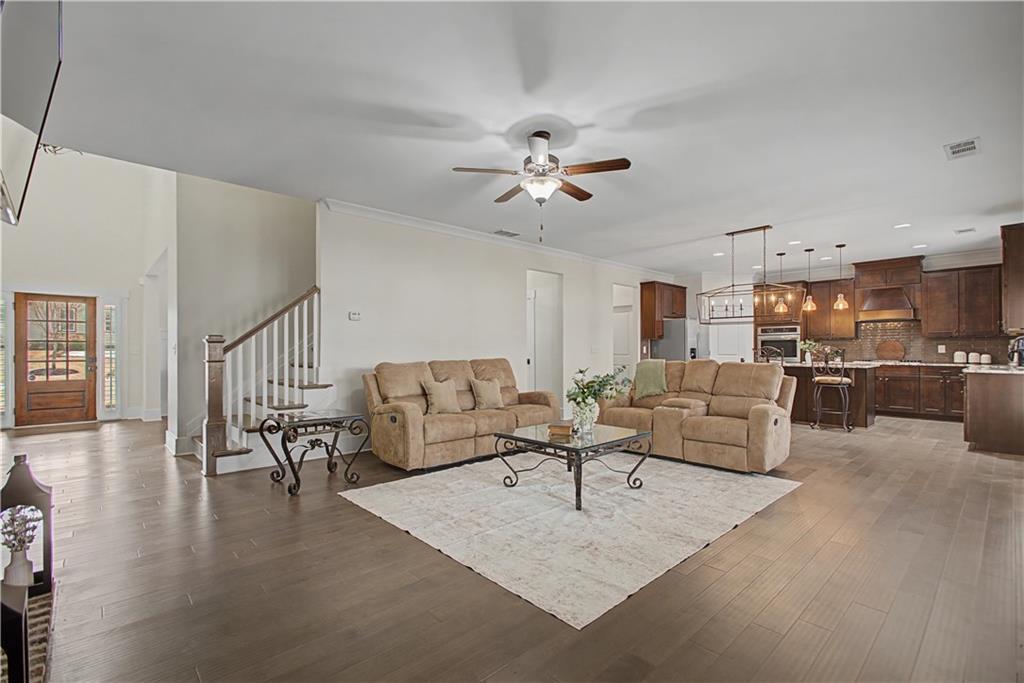 3769 Cheyenne Lane Jefferson, GA 30549 - Photo 14 of 49 a living room with furniture dining table a lamp and a kitchen view
