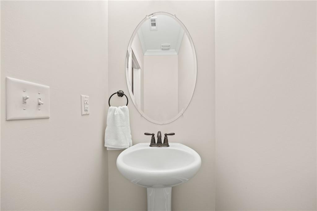 3769 Cheyenne Lane Jefferson, GA 30549 - Photo 20 of 49 a bathroom with a sink a mirror and a toilet