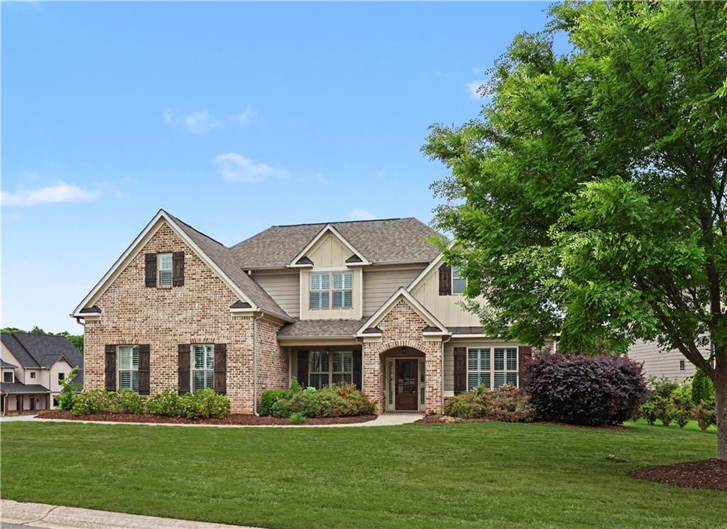 3769 Cheyenne Lane Jefferson, GA 30549 - Photo 2 of 49 a front view of a house with a garden and trees