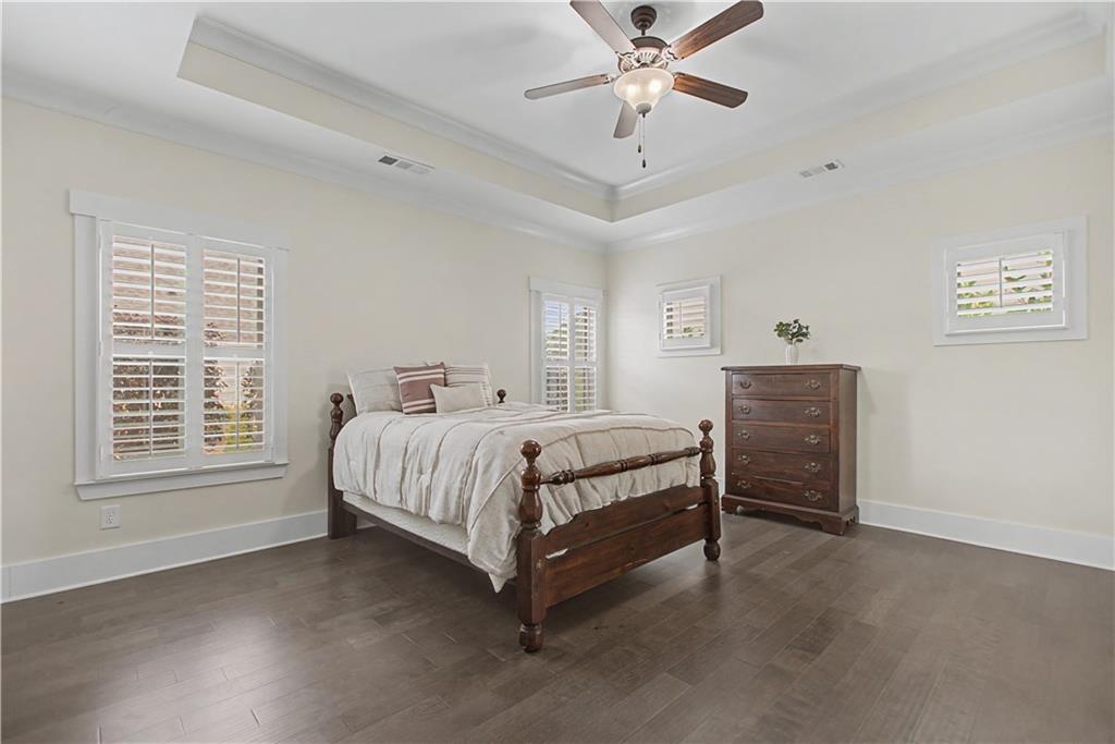 3769 Cheyenne Lane Jefferson, GA 30549 - Photo 23 of 49 a spacious bedroom with a bed and a chandelier