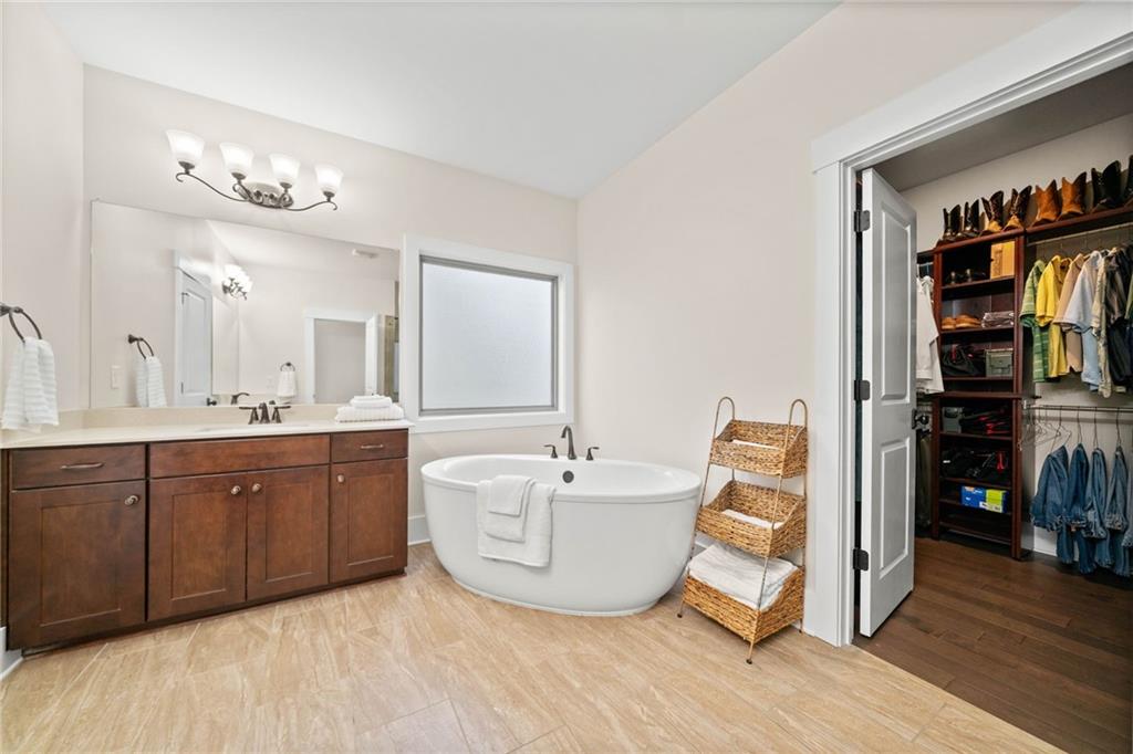 3769 Cheyenne Lane Jefferson, GA 30549 - Photo 26 of 49 a spacious bathroom with double vanity sinks a large mirror and a shower