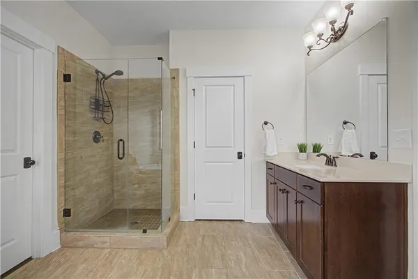 a bathroom with a shower sink and mirror