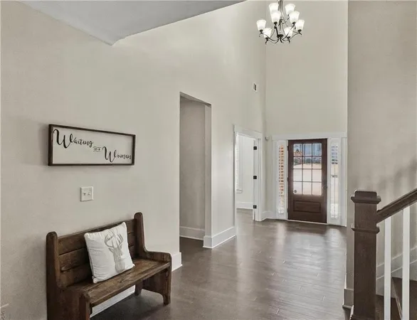 a hallway with furniture and wooden floor