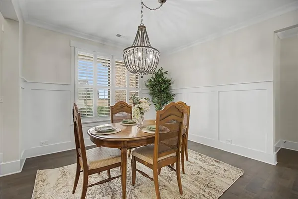 a dining room with furniture and chandelier