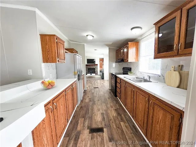 a kitchen with stainless steel appliances a sink and a refrigerator