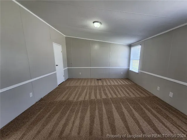 a view of a room with wooden floor and window