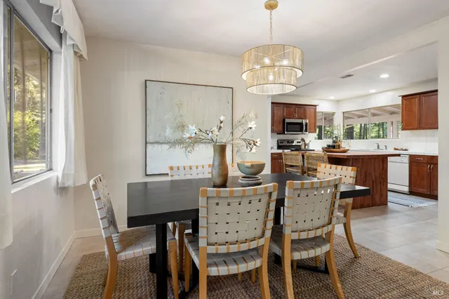 a dining room with furniture and window