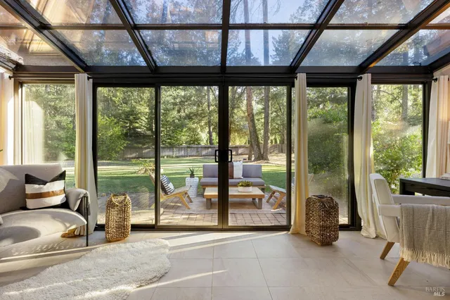a living room with furniture and large windows