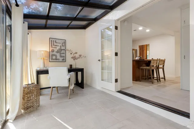 a view of a house with a yard balcony and wooden fence
