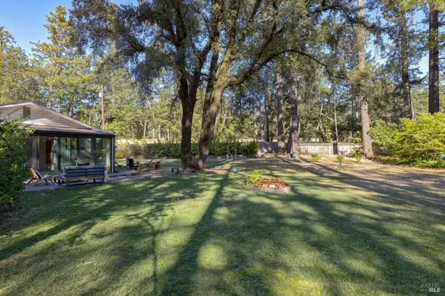 a view of a backyard with table and chairs
