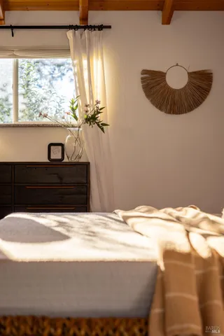 a bedroom with a bed and a lamp