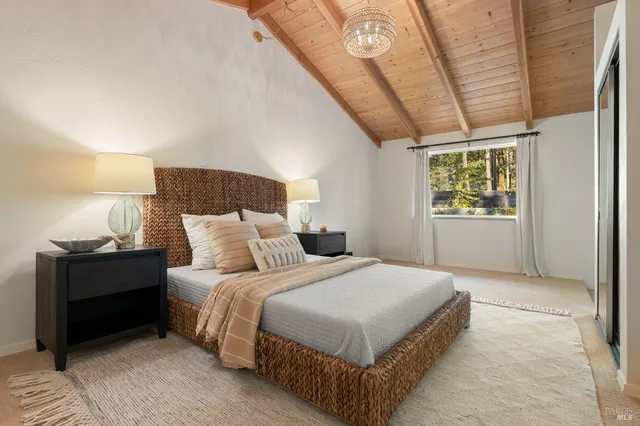 a bedroom with a bed and large glass window