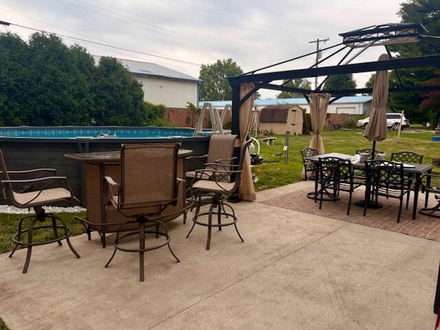 806 North 4th Street Kentland, IN 47951 - Photo 5 of 29 a view of a patio with a table and chairs under an umbrella