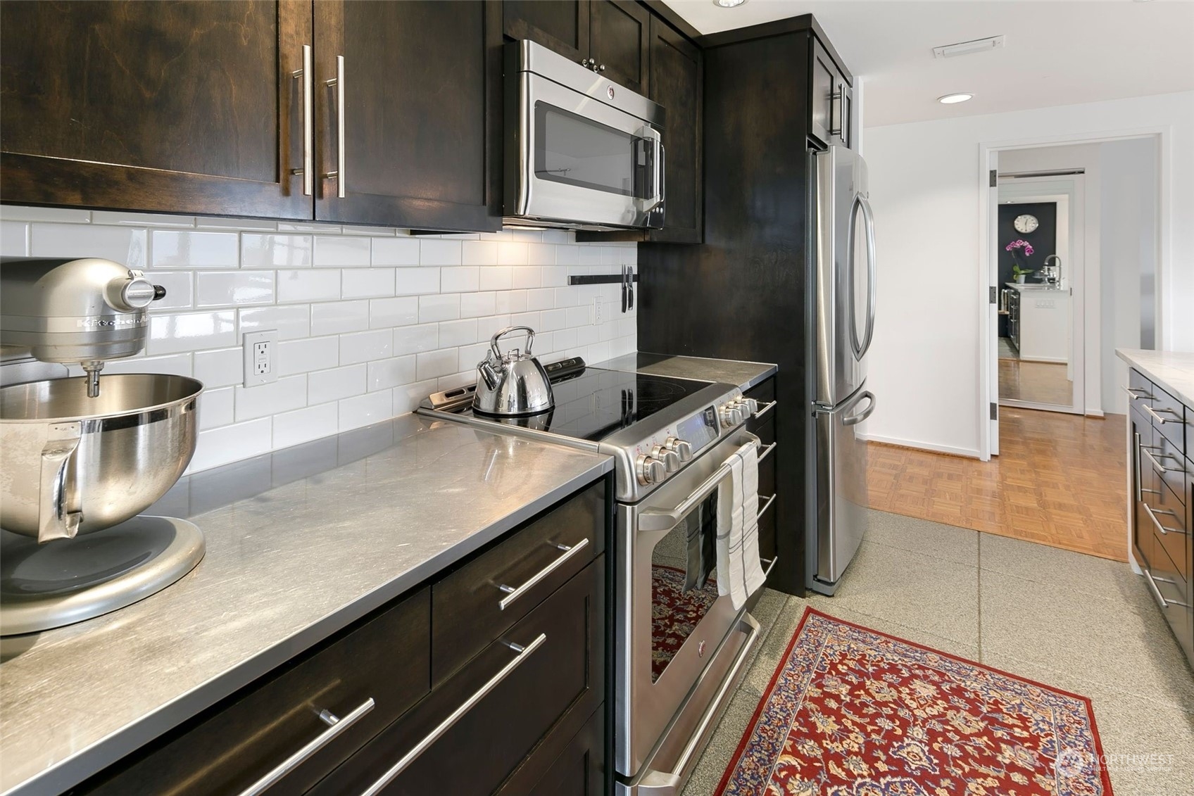 1301 Spring Street, Unit 6A Seattle, WA 98104 - Photo 8 of 33 a kitchen with a sink and a stove top oven