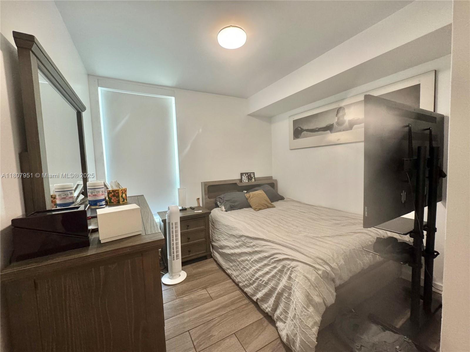 1600 Southwest 1st Avenue, Unit 910 Miami, FL 33129 - Photo 11 of 11 a bedroom with double bed and a flat tv screen on a dresser