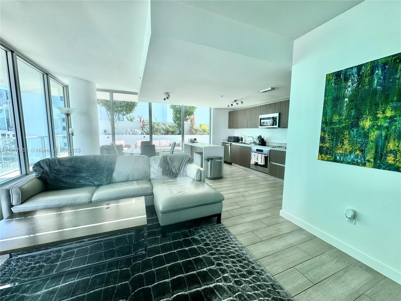 1600 Southwest 1st Avenue, Unit 910 Miami, FL 33129 - Photo 4 of 11 a living room with furniture and a large window