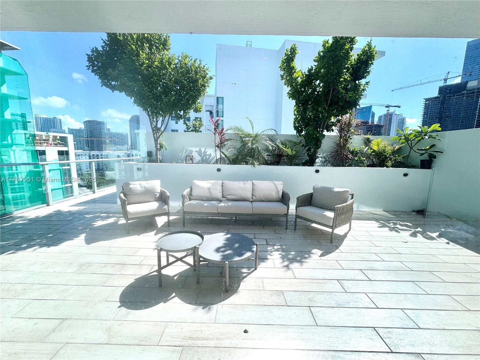 1600 Southwest 1st Avenue, Unit 910 Miami, FL 33129 - Photo 5 of 11 a view of a patio with couches and pool