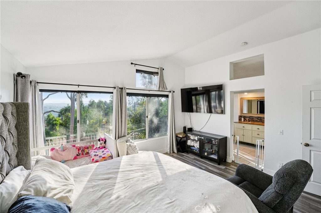 17586 Mountain Court Riverside, CA 92503 - Photo 17 of 39 a bedroom with a bed a flat tv screen and a dresser