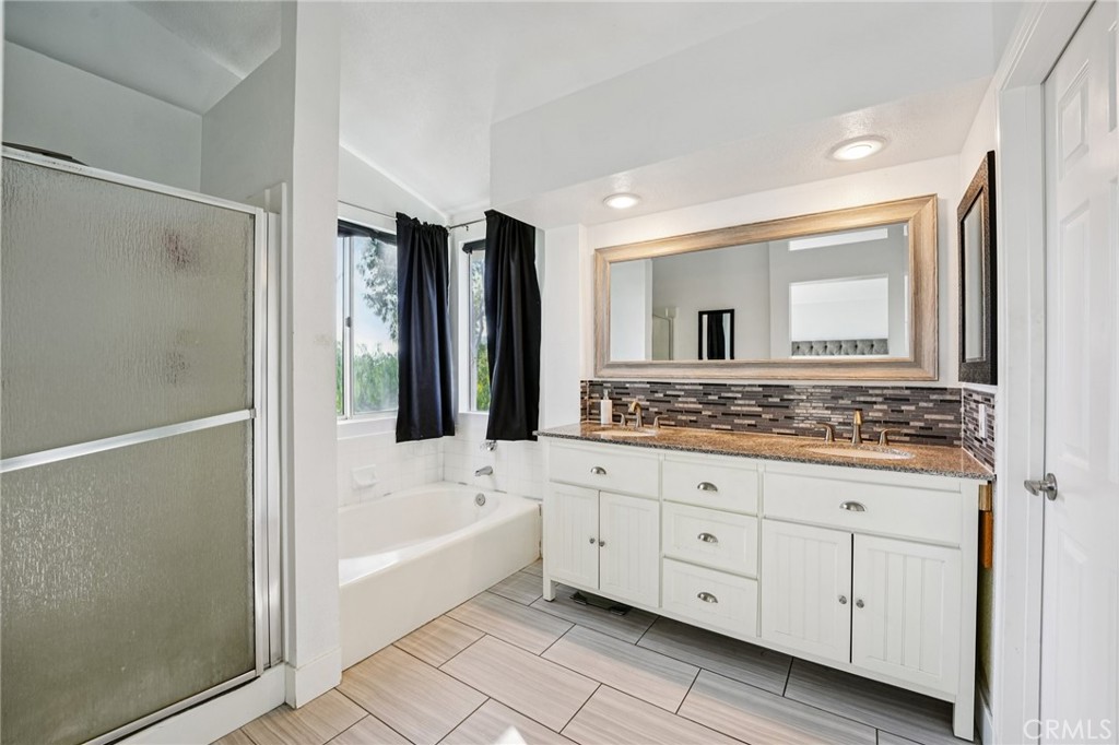 17586 Mountain Court Riverside, CA 92503 - Photo 18 of 39 a bathroom with a granite countertop sink mirror and bathtub