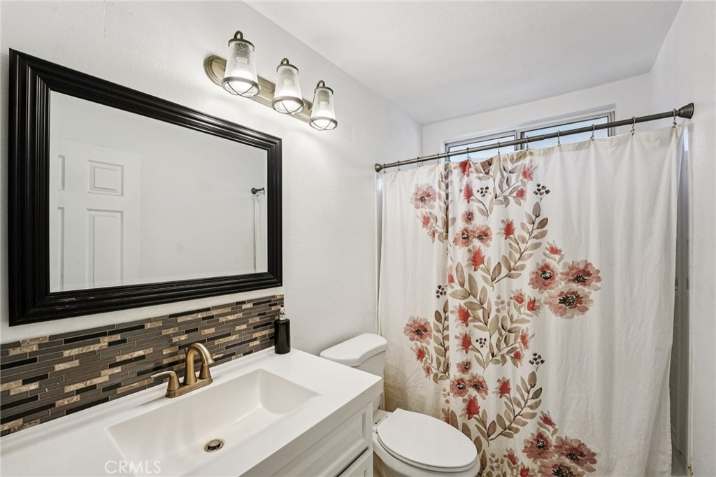 17586 Mountain Court Riverside, CA 92503 - Photo 21 of 39 a bathroom with a sink and a mirror