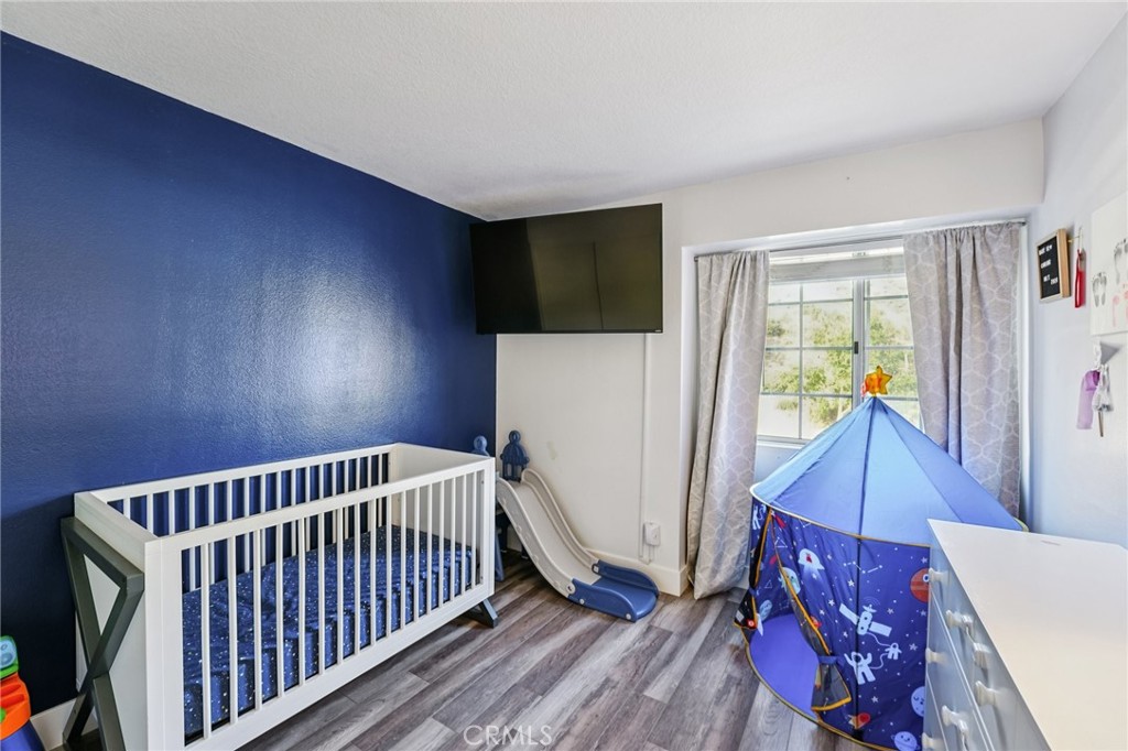 17586 Mountain Court Riverside, CA 92503 - Photo 23 of 39 a bedroom with furniture and wooden floor