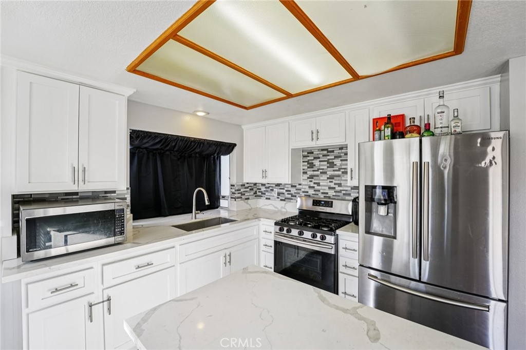 17586 Mountain Court Riverside, CA 92503 - Photo 10 of 39 a kitchen with stainless steel appliances a refrigerator stove and microwave